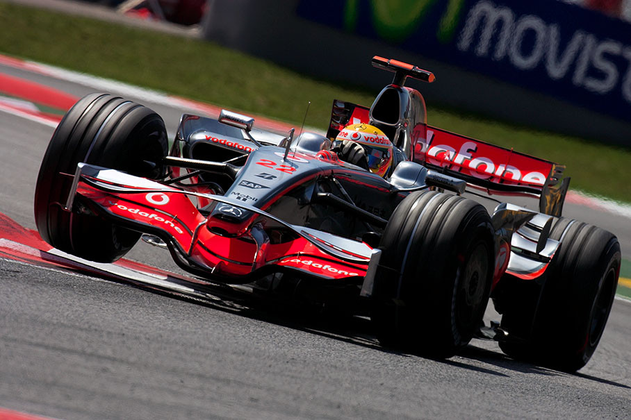 McLaren Mercedes driver Lewis Hamilton lifts a wheel at the 'new' chicane