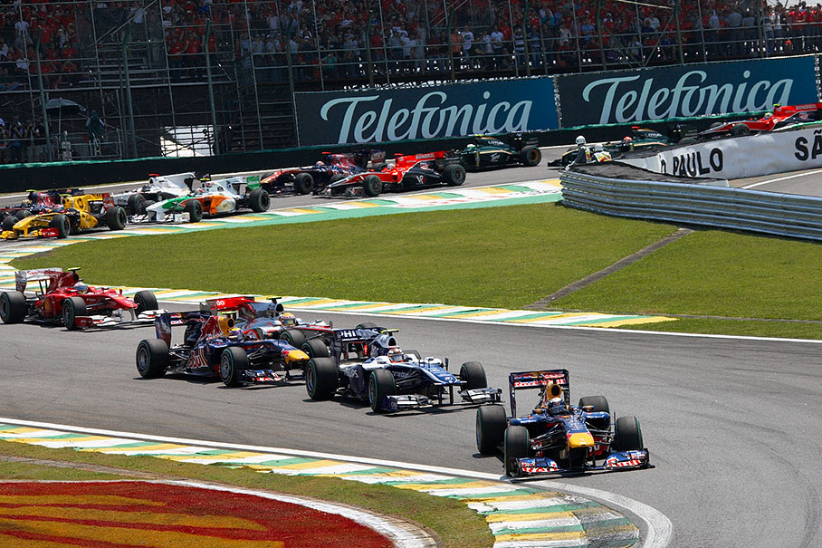 The start field approaches turn two, Vettel takes the lead over