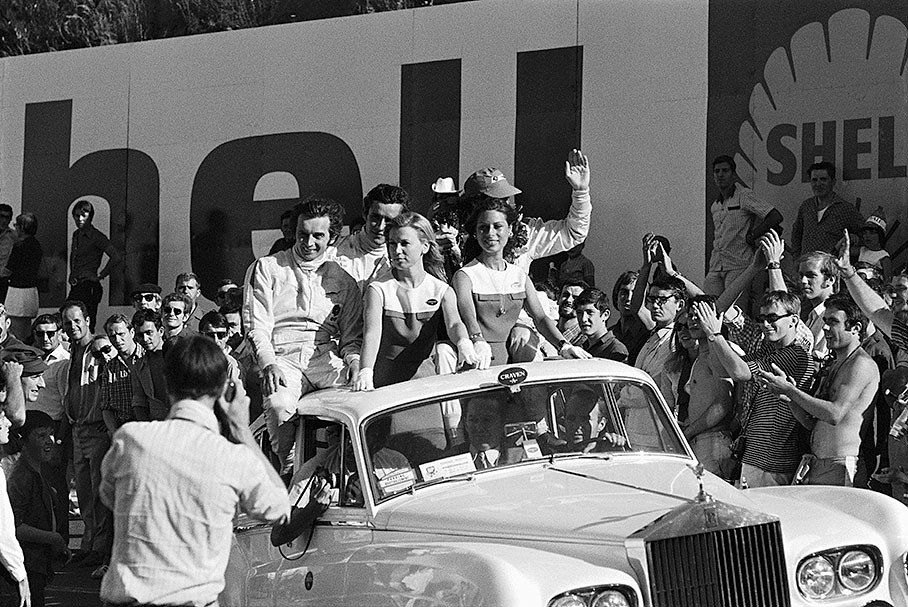 Race winner Jackie Stewart (covered, right hand), second placed Jean-Pierre Beltoise (left hand) and third Jacky Ickx enjoy their victory surrounded by cheering crowds after the French GP 1969