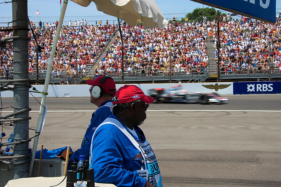 American marshals watching the action of a passing McLaren