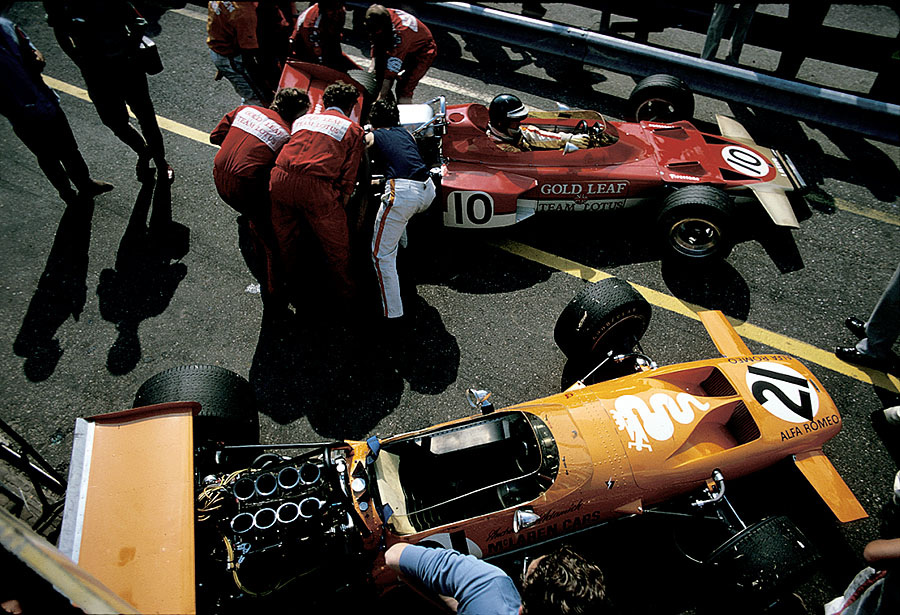 Whilst Jochen Rindt on Lotus-Cosworth 72C is eager to go out to practice, Andrea de Adamich's McLaren-Alfa Romeo M14D waits for preparation in the pitlane