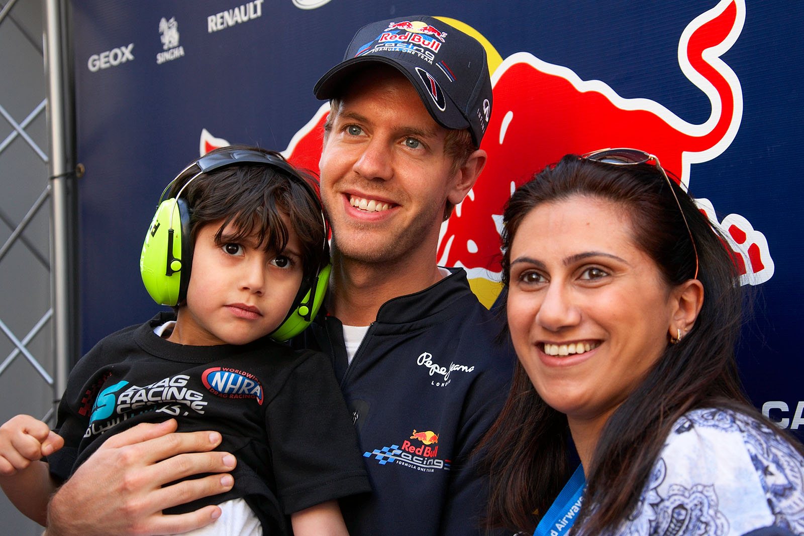A patient double World Champion Sebastian Vettel poses with devoted fans for a souvenir photo