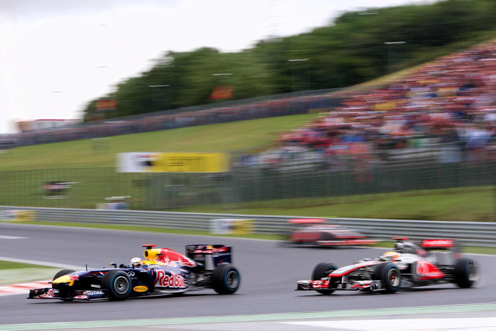 Sebastian Vettel, Red Bull Racing, and Lewis Hamilton, McLaren Mercedes, battle for the leading position
