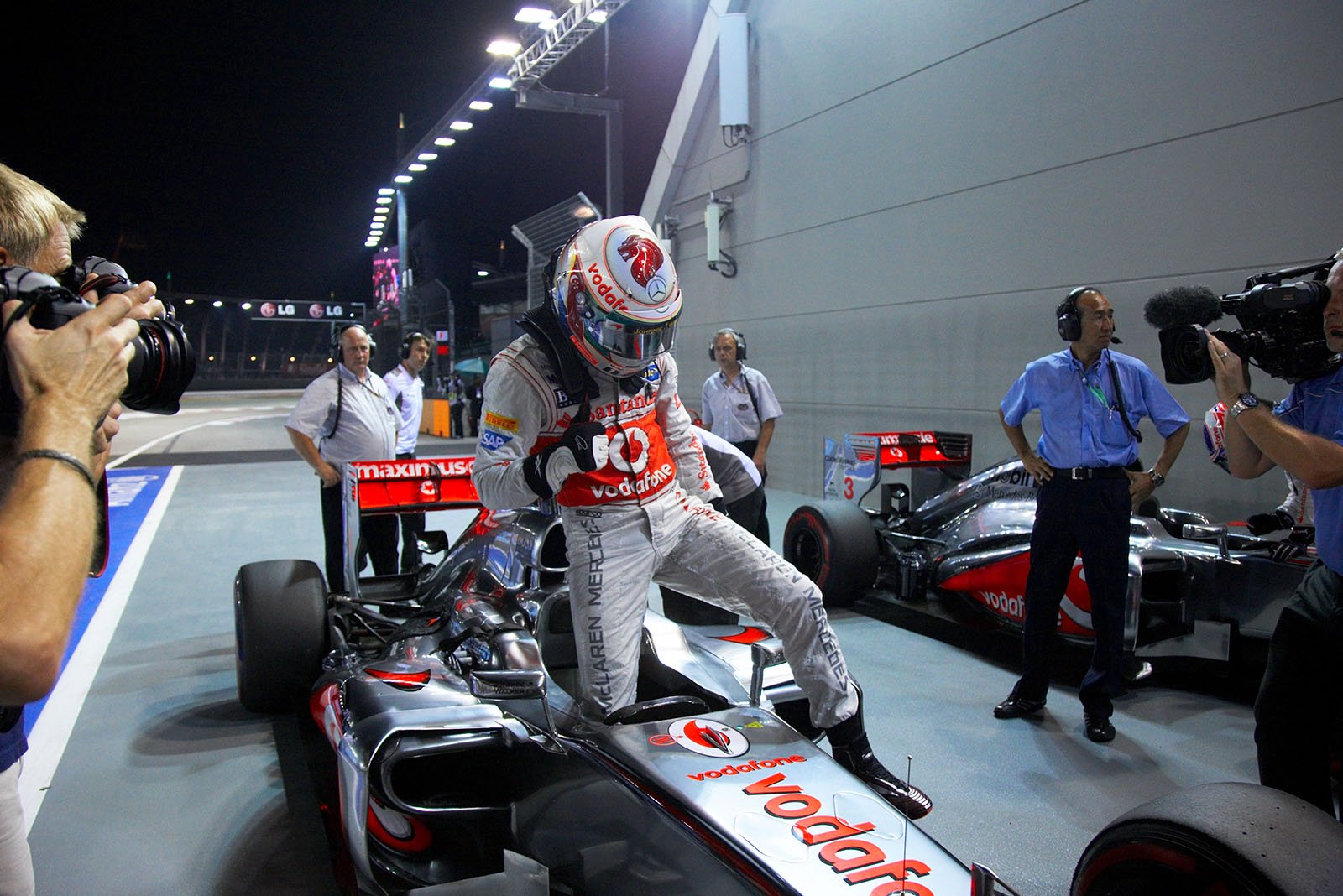 Polesetter Lewis Hamilton of McLaren gets out of his race car in parc ferme after qualifying