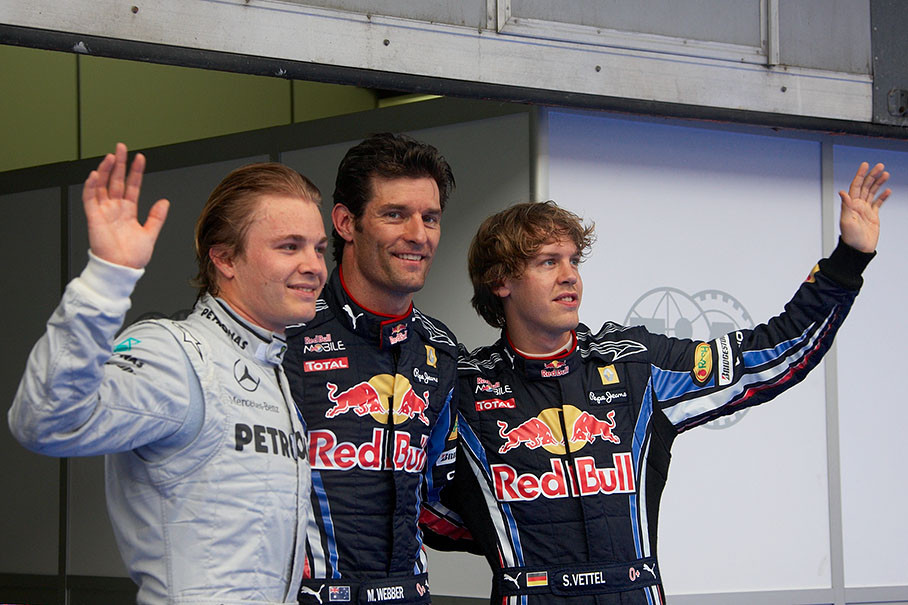 The fastest three qualifiers wave at the world's media: on the left hand second qualified happy Nico Rosberg, Mark Webber as polesetter in the middle and his Red Bull team mate Sebastian Vettel as third on the grid