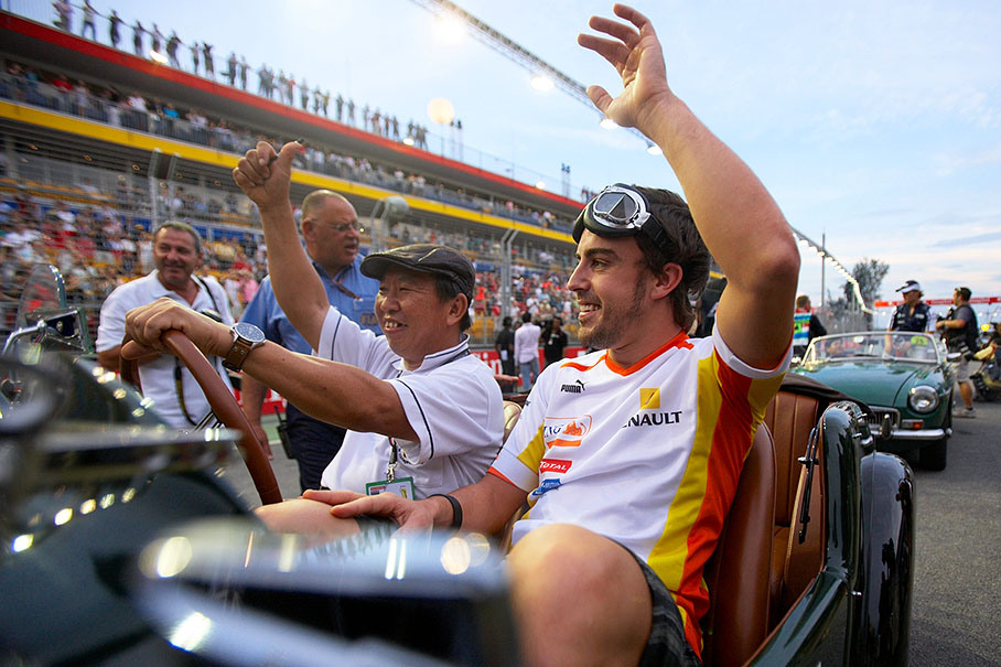Renault F1's Fernando Alonso waves at the fans during drivers parade