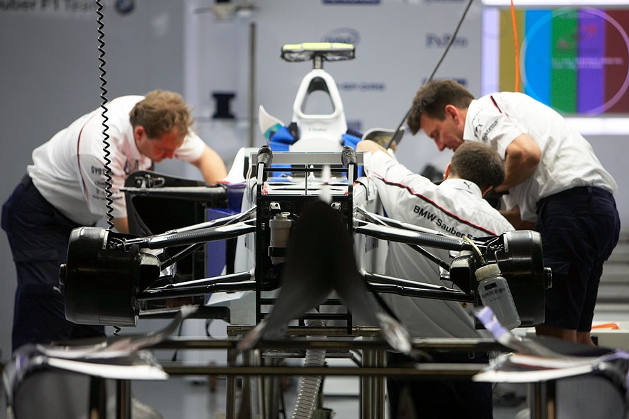 BMW Sauber mechanics work on the body of the BMW Sauber car in pits