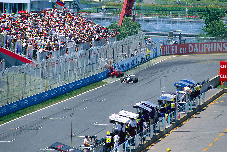 Under pressure from Mika Hakkinen, Michael Schumacher hits the wall with his Ferrari on lap 29. The second McLaren of Coulthard passes the scene.