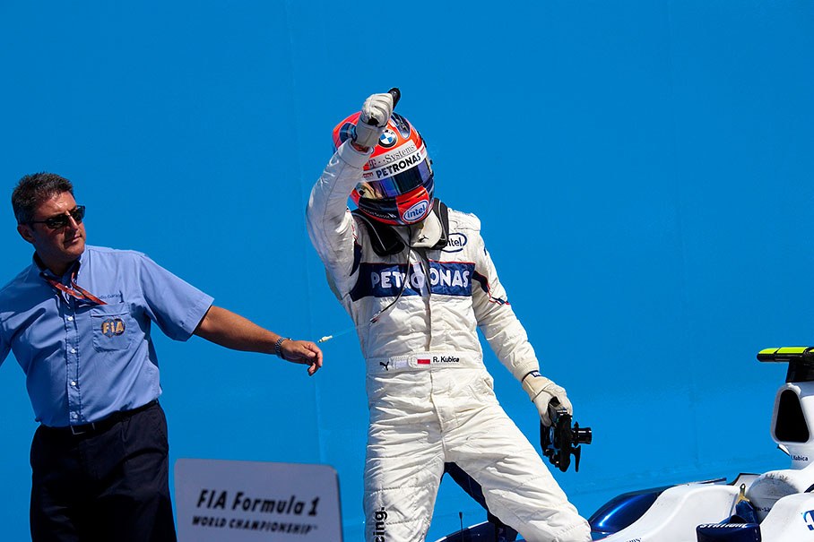 Third placed Kubica greets the spectators from parc ferme