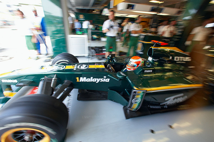 Jarno Trulli deploys from Lotus Racing pits
