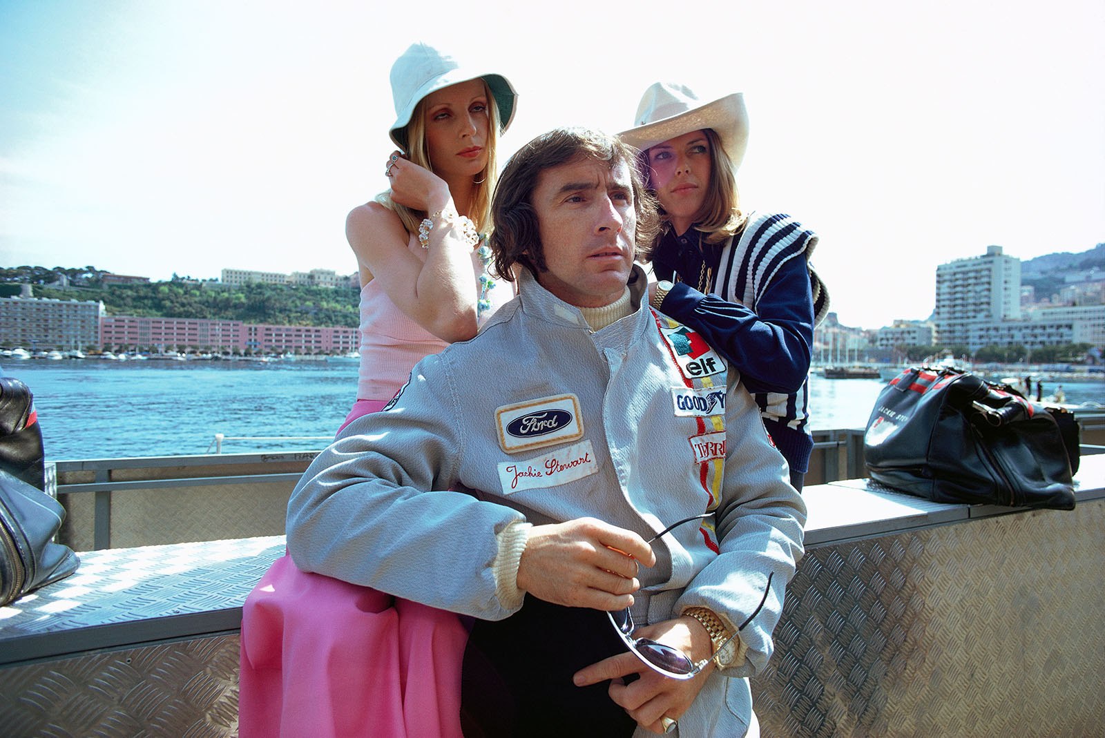 Jackie Stewart poses for an advertising shooting with his wife Helen (right) and a promotional girl, Monaco Grand Prix, 1972