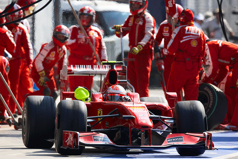 Ferrari's Kimi Raikkonen finishes his pit stop