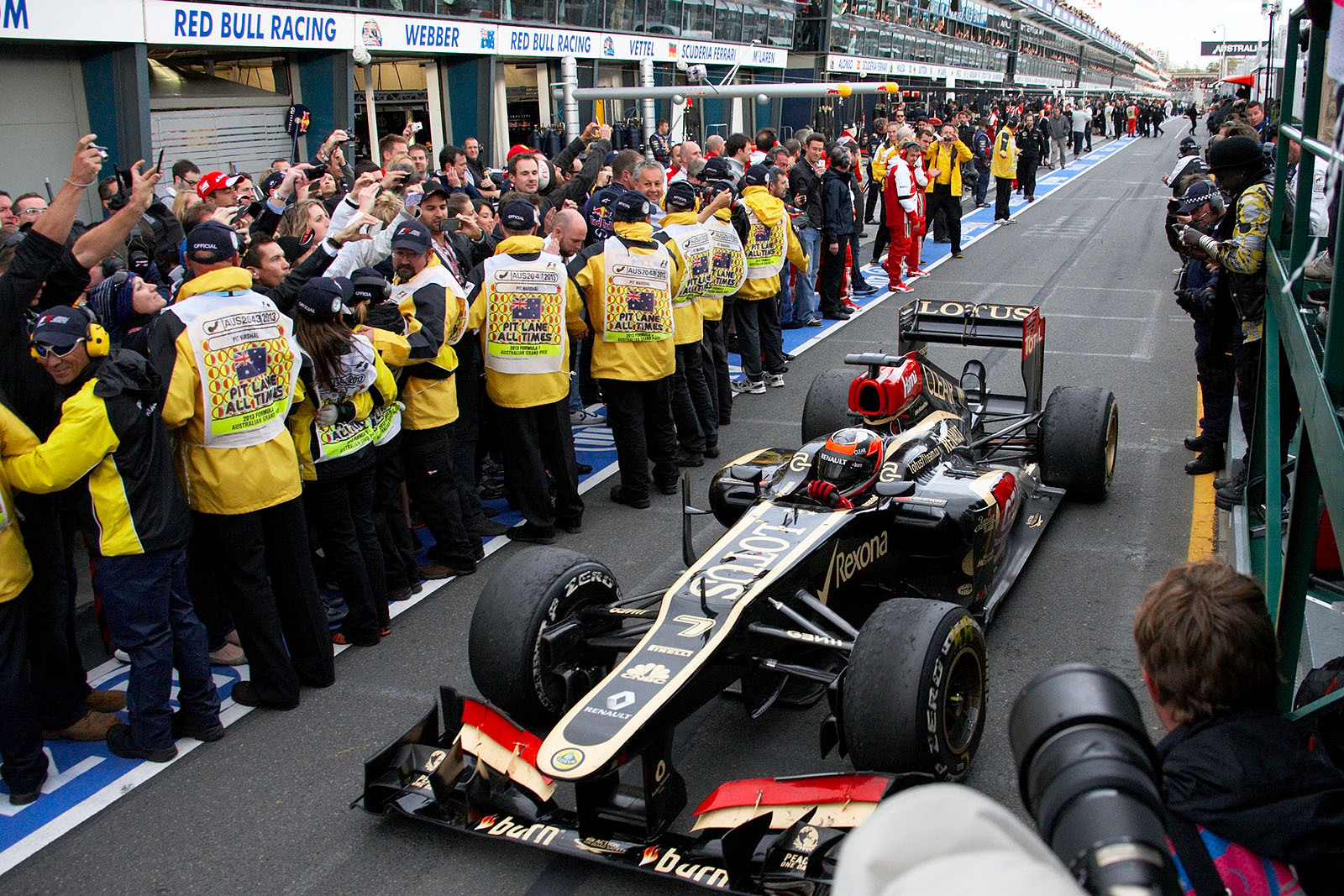 Race winner Kimi Raikkonen, Lotus F1, approaches parc ferme through the pitlane