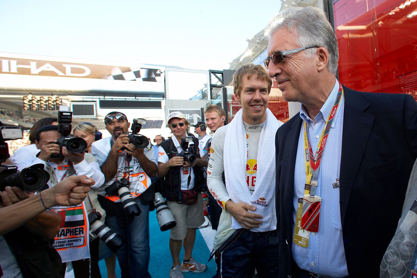 Piero Lardi Ferrari, Ferrari Vice-President, chats besides the grid with Sebastian Vettel and in front of many lenses