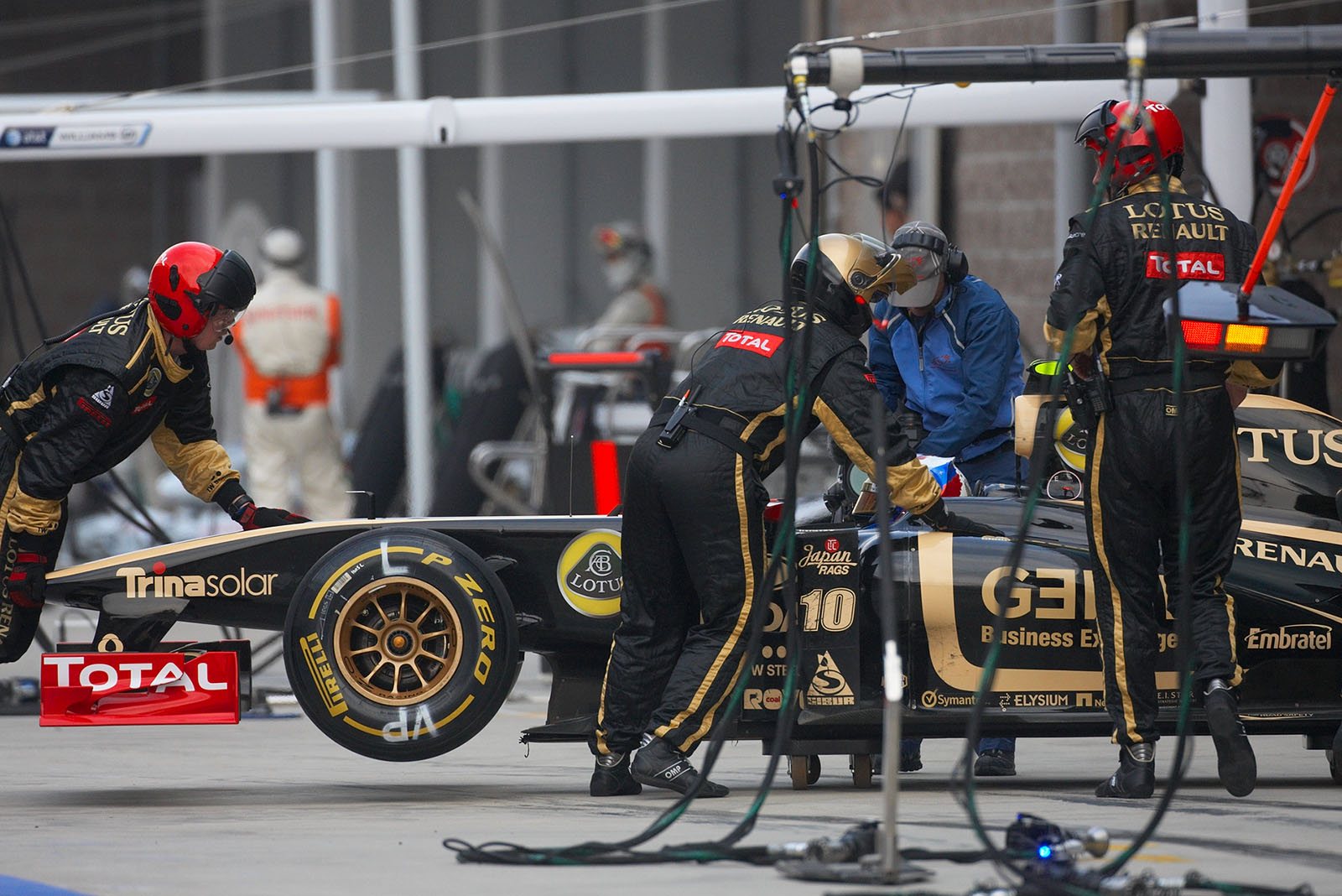 Vitaly Petrov retires in Lotus Renault GP pits after a collision with Schumacher