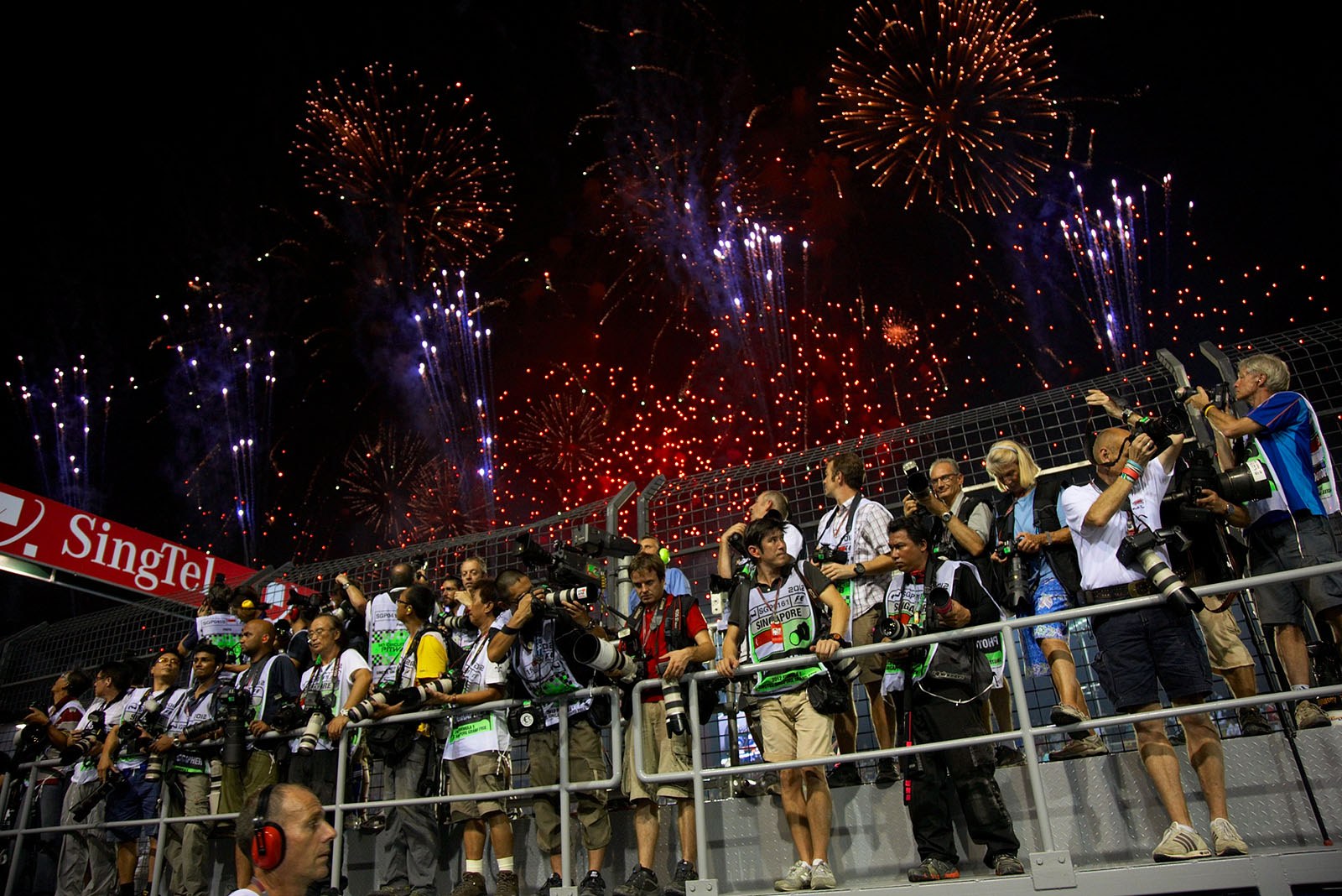 After the race, fireworks illuminate the sky above the waiting photographers