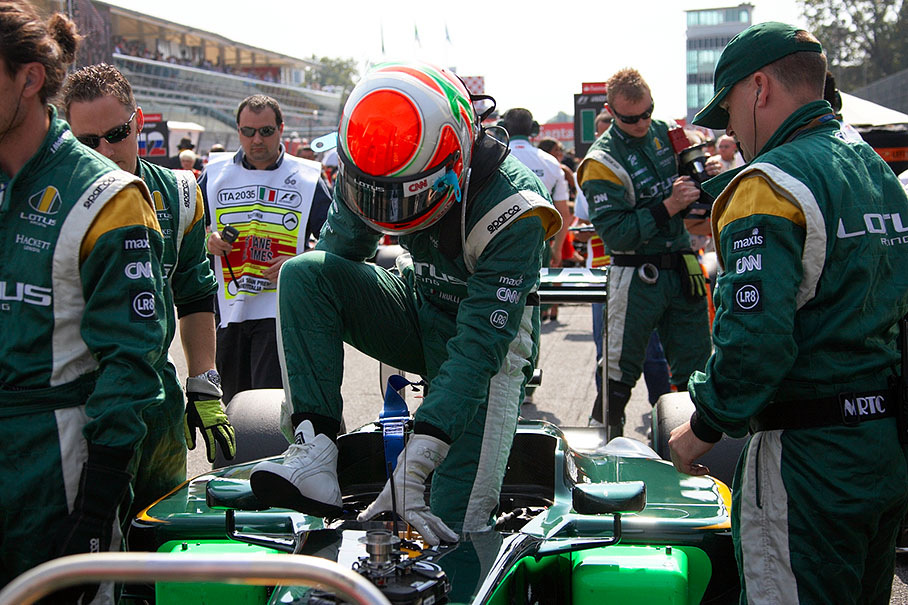 Jarno Trulli climbs out of his Lotus car on the grid