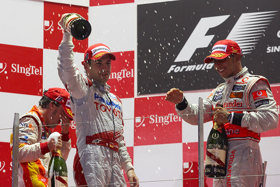 Second placed Timo Glock shakes his bottle of champagne