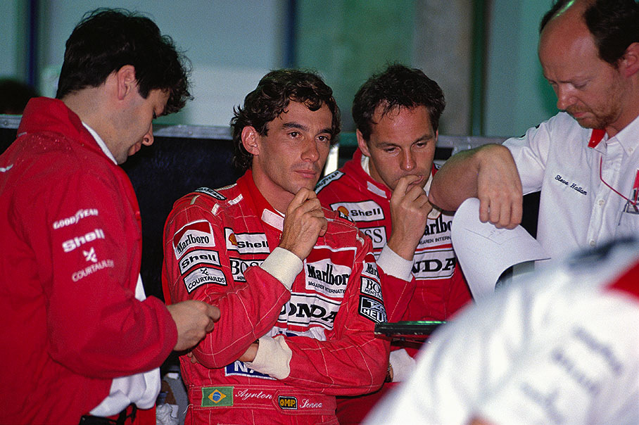Brazilian McLaren-Honda driver Ayrton Senna with team-mate Gerhard Berger surrounded by engineers James Robinson (left) and Steve Hallam