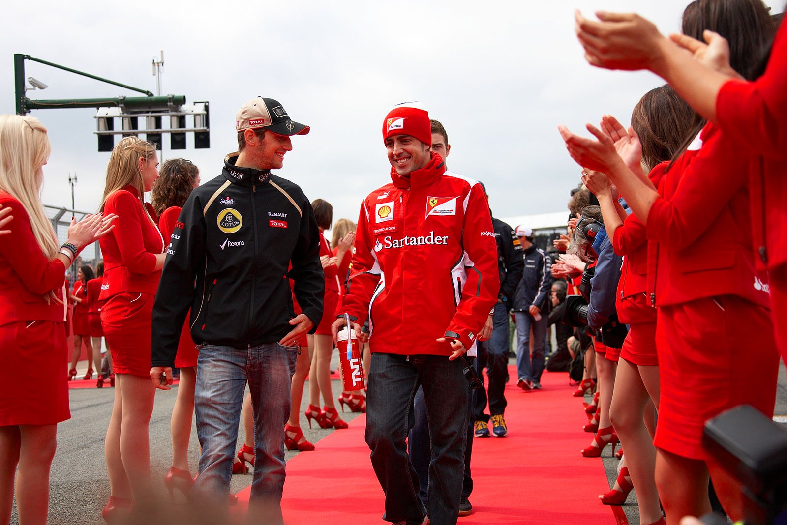 Renault's Grosjean and Fderrari's Alonso walk together to the drivers parade