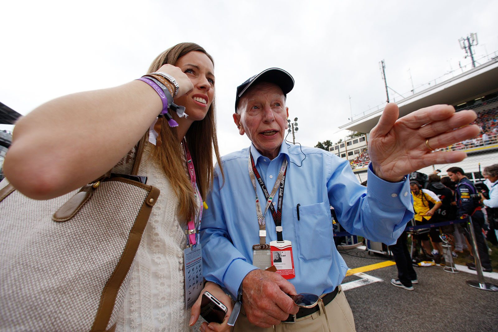 1964 Formula One World Champion with Ferrari and Seven times motorcycle racing Champion, Sir John Surtees, with one of his pretty daughters on the grid before the race