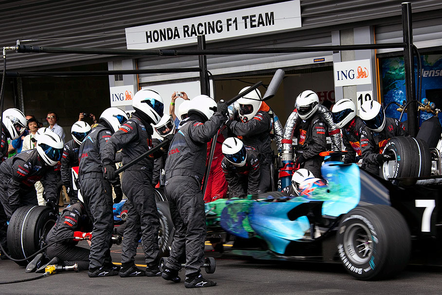 Jenson Button comes in to being serviced