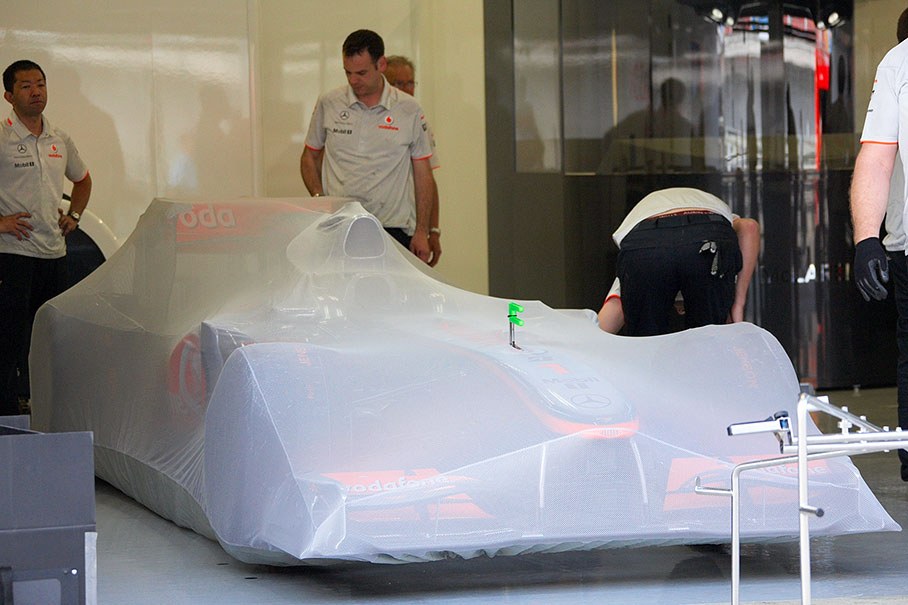 After scrutineering on Saturday afternoon, the McLaren cars are sealed in the team's pits under FIA's parc ferme regulations with a translucent fabric cover
