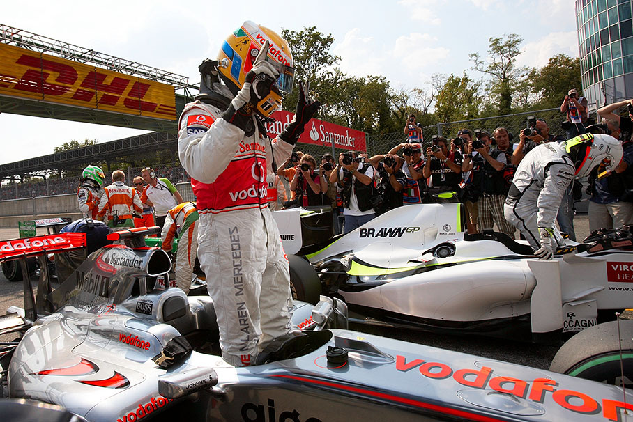 Polesetter Hamilton climbs out of the McLaren Mercedes car in parc ferme and shows his  excitement