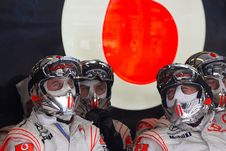 Prepared McLaren mechanics wait in pits