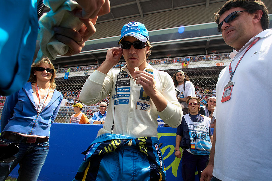 World Champion Fernando Alonso on the grid preparing his earplugs