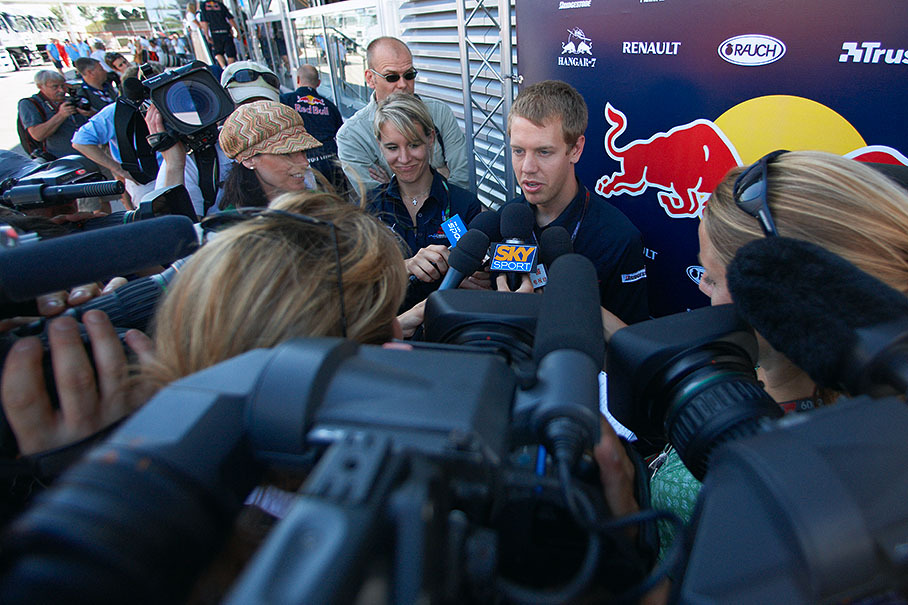 Red Bull's sunnyboy Sebastian Vettel surrounded by the international media