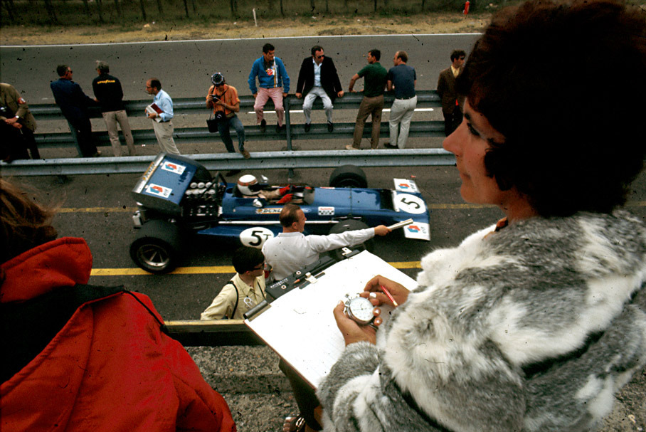 Bette Hill keeps her husband's times whilst Jackie Stewart passes her in pitlane
