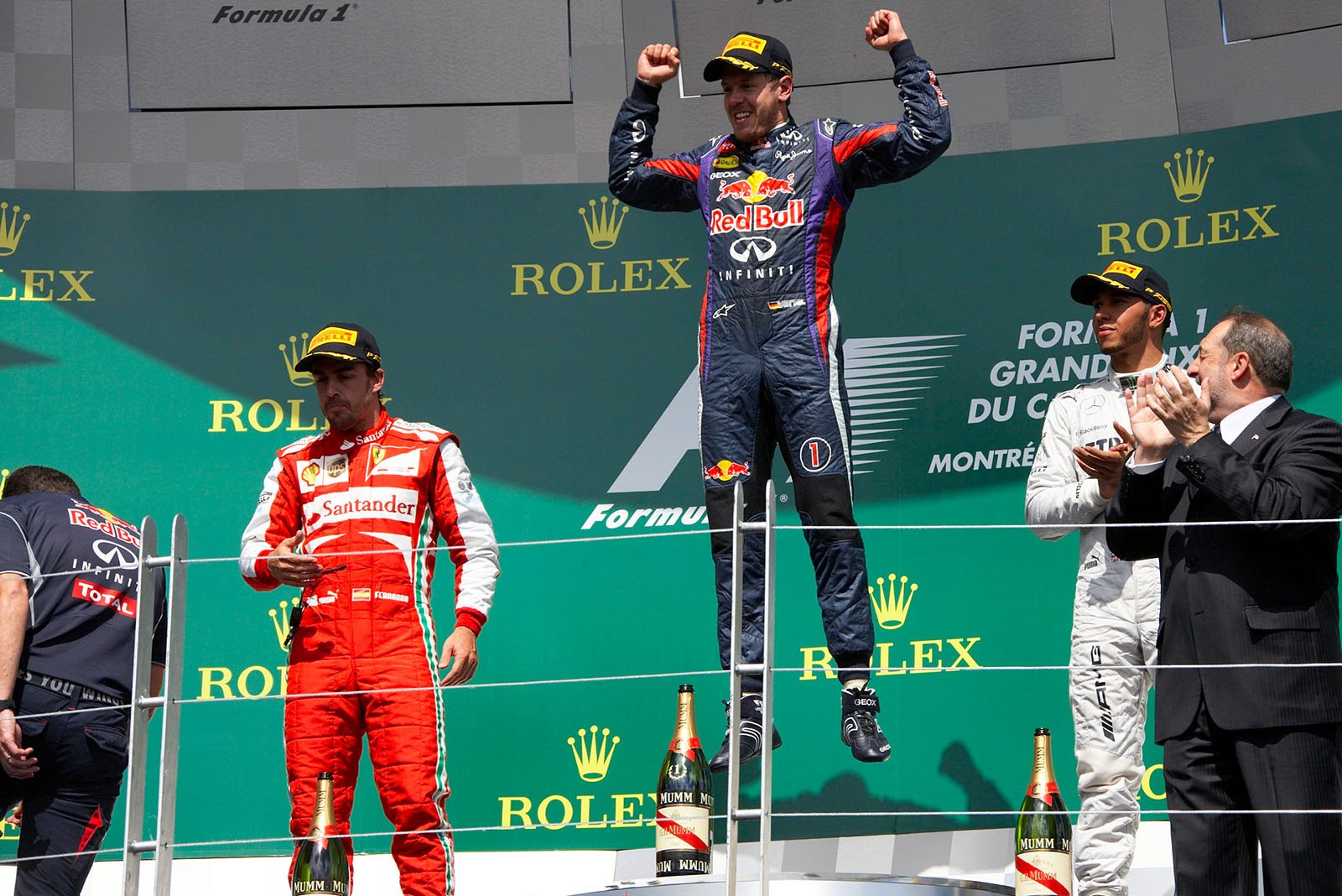 Race winner Sebastian Vettel of Red Bull Racing jumps at the podium during the ceremony