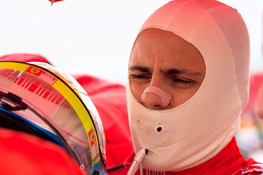 Felipe Massa puts his race helmet on