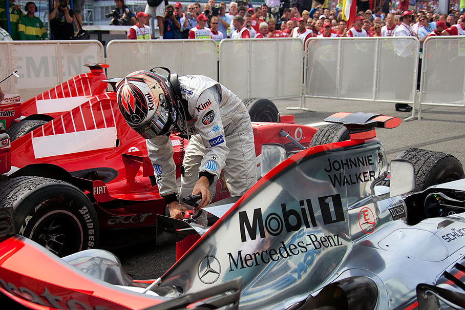 Kimi Raikkonen grabbing a fire extinguisher