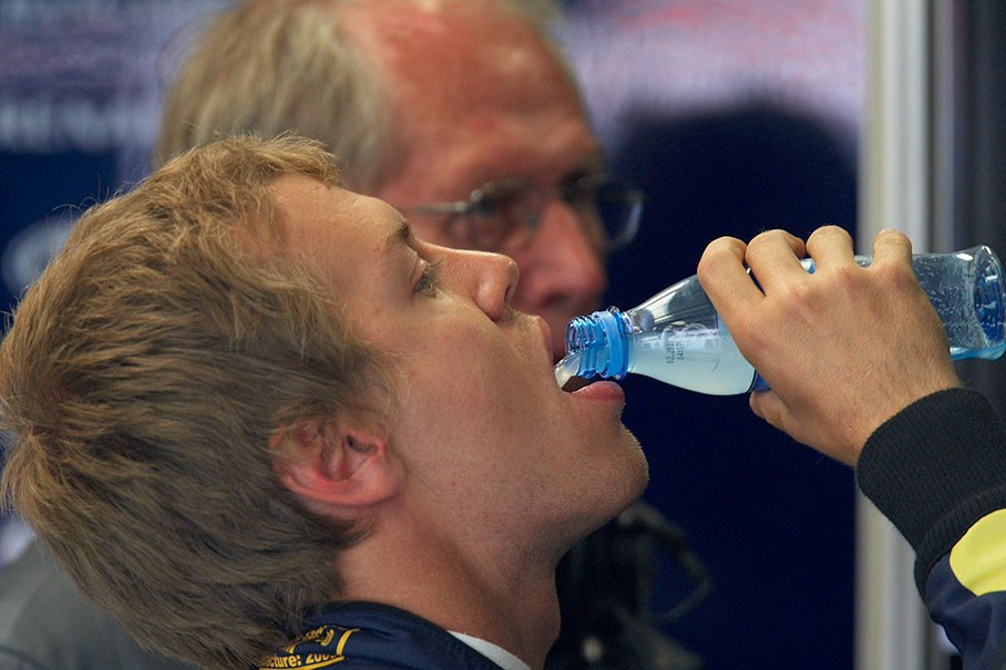 A thirsty Sebastian Vettel in Red Bull Racing pits