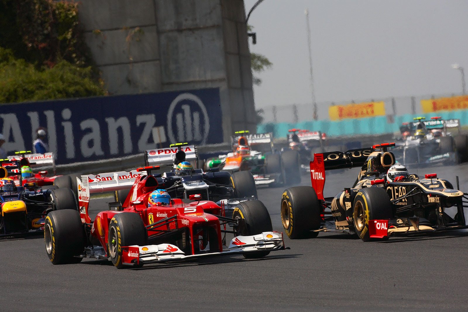 Fernando Alonso, Ferrari, comes behind Raikkonen
