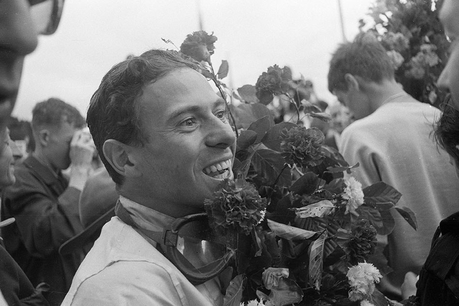 Jim Clark, winner of the Belgian GP 1964, takes a bath in the masses after his successful race.