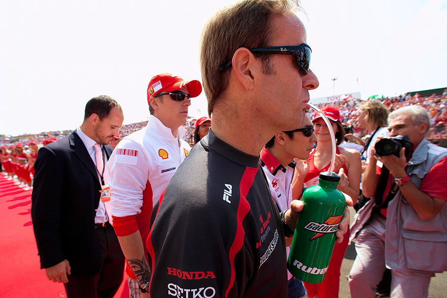 Rubens Barrichello and Takuma Sato, being followed by Kimi Raikkonen