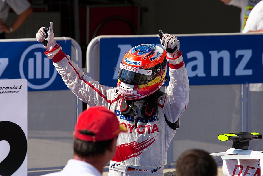 Second placed Timo Glock shows both thumbs up in parc ferme