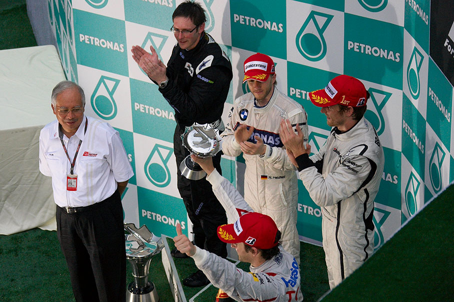 Third placed Timo Glock cheers at his fans from podium