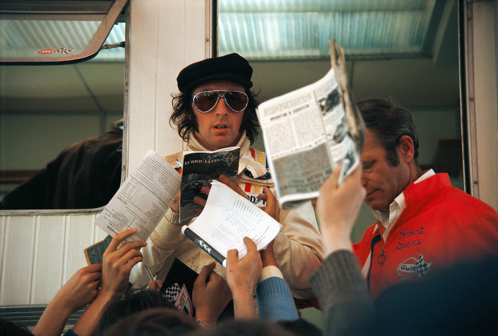 Race winner Jackie Stewart signs autographs