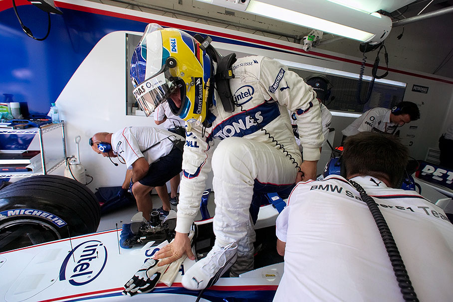 Nick Heidfeld jumping out of his cockpit
