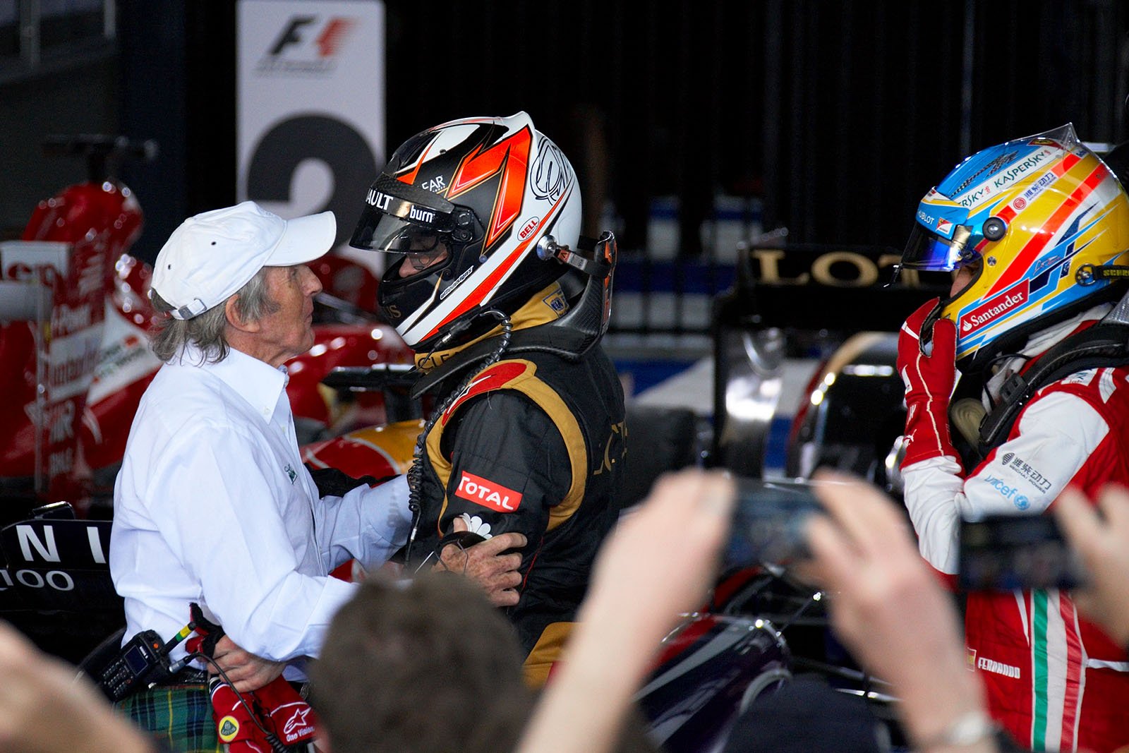 Lotus ambassador and triple F1 World Champion Sir Jackie Stewart congratulates race winner Kimi Raikkonen in parc ferme