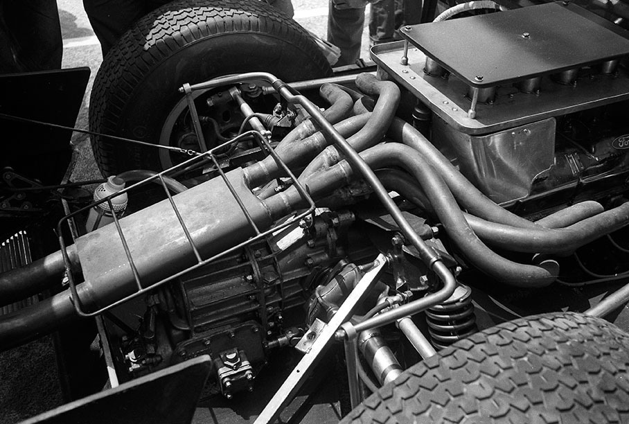 A Ford GT40's engine compartment and exhaust pipes