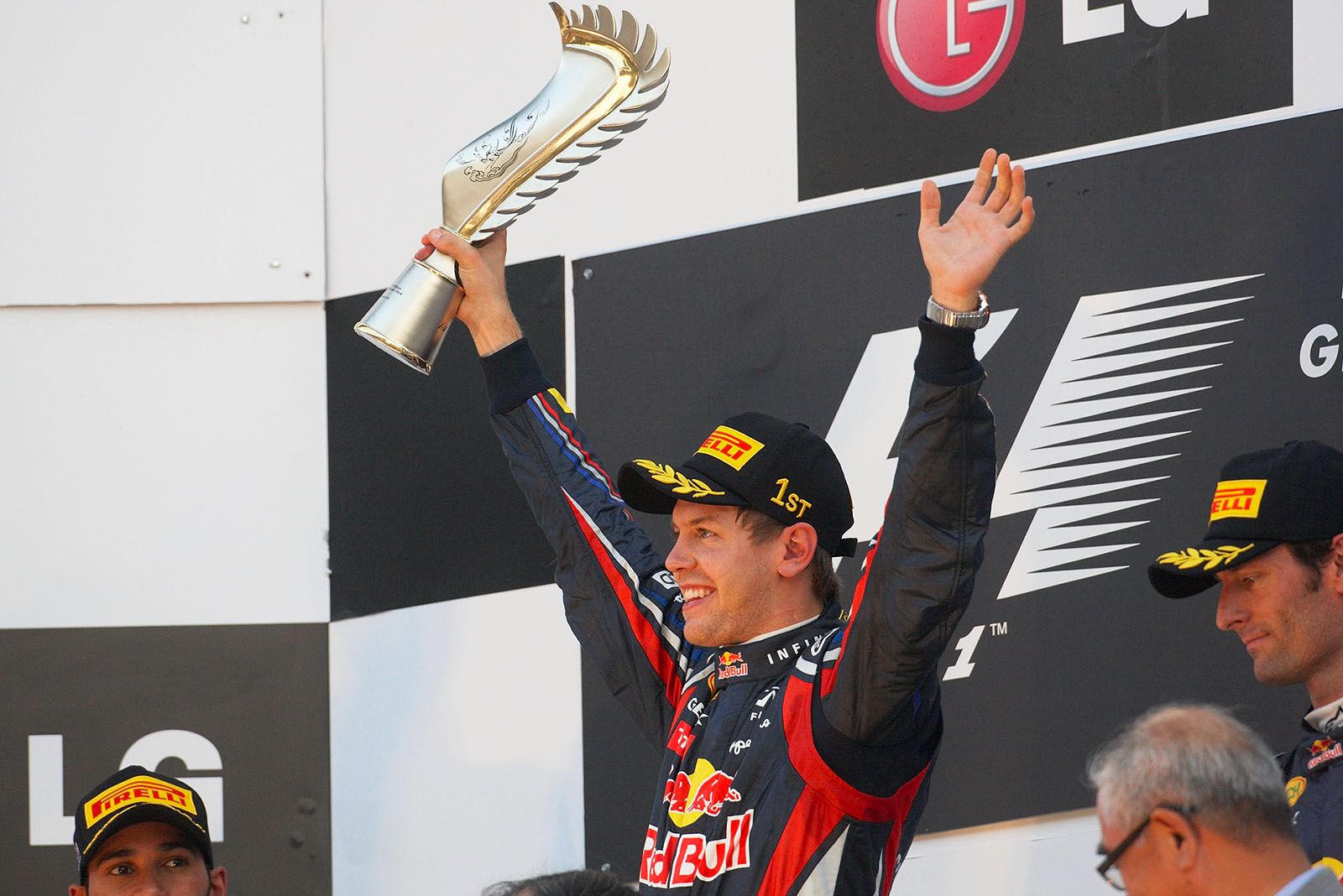 Sebastian Vettel, Red Bull Racing, presents his trophy on the podium after winning the Korean GP