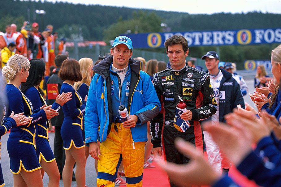 Jenson Button and Mark Webber walk between applauding grid girls on Sunday's drivers parade