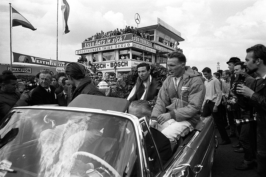 Third placed Dan Gurney and winner Jim Clark celebrate after the German GP 1965