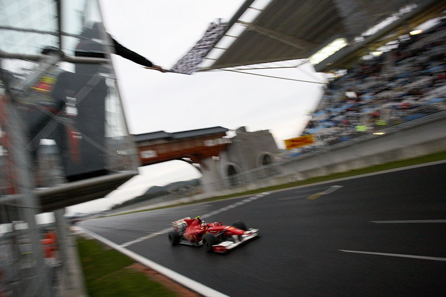 Fernando Alonso of Ferrari takes the chequered flag, wins the first Korean GP and retakes the lead in the drivers championship