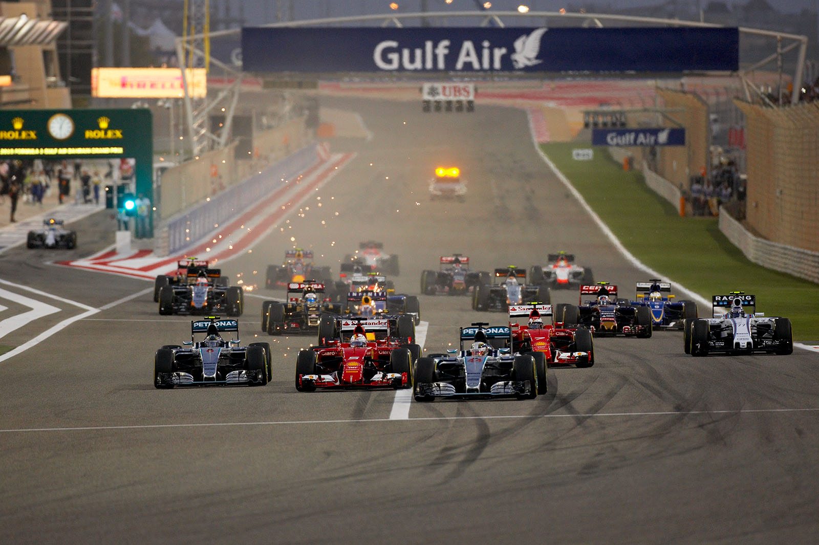 Lewis Hamilton, Mercedes, brakes for the first corner, as Rosberg, Vettel and Raikkonen battle for 2nd position, Bahrain Grand Prix, 2015